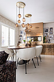 Dining area with modern pendant lights and photo wall