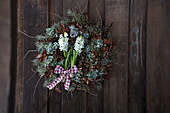 Winter wreath made of natural materials with dried twigs and white hyacinths