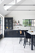 Modern kitchen with black cabinets and marble worktop