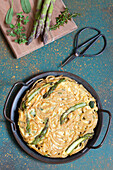 Pasta omelet with asparagus, zucchini and provolone cheese