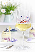 White wine in a wine glass with berry motif