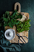 Fresh organic mint leaves on a rustic wooden board