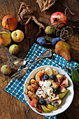 Fresh autumn fruit with yogurt and chocolate