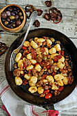 Gnocchi with tomatoes, sausage and olives
