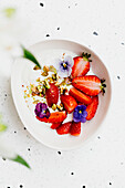 Yogurt cream with tahini, strawberries and pistachios