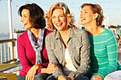 Three good-humoured girlfriends on a ship