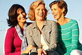 Three good-humoured girlfriends on a ship