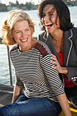 Three good-humoured girlfriends on a ship