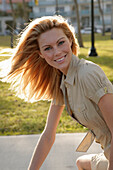 Blonde woman in light blouse dress outside