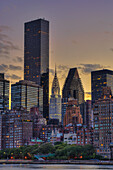 Midtown Manhattan Skyline With Chrysler Building At Sunset As Viewed From Roosevelt Island; New York City, New York, United States Of America