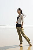 Young Woman Walking On The Beach From Huohu, North Of Kinmen Island; Huohu, Taiwan