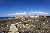 A Rugged Stone Path Across An Arid Landscape At The Water's Edge; Paphos, Cyprus