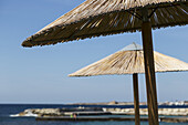 Umbrellas At The Water's Edge; Paphos, Cyprus