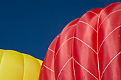 Yellow And A Red Hot Air Balloons Lift Up Into The Sky As They Fill With Hot Air And Prepare For Lift-Off; Filzmoos, Austria