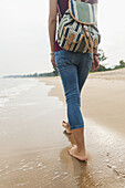 Chinese Girl Walking Along Xiamen's Beach; Xiamen, Fujian Province, China