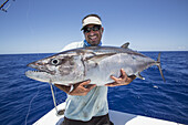 Fisherman Holding A Fresh Caught Dogtooth Tuna (Gymnosarda Unicolor); Tahiti