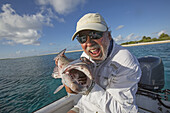 Fisherman Holding A Fresh Caught Grouper; Tahiti
