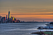 Sunset Over Lower Manhattan And The Verrazano-Narrows Bridge; Weehawken, New Jersey, United States Of America