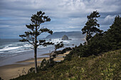 Haystack Rock And Tillamook Head, Coastal Landmarks; Tolovana, Oregon, United States Of America