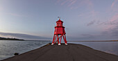 Roter Leuchtturm entlang der Küste bei Sonnenuntergang; South Shields, Tyne And Wear, England