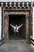 A Woman Stands In An Ornate Doorway, Rinpung Dzong; Paro, Bhutan