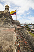 Castillo San Felipe De Barajas And Colombian Flag With Cartagena New City In Background; Cartagena, Columbia