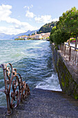Wind Sends Lake Como Water Splashing Against A Waterfront Staircase And Sidewalk; Bellagio, Italy