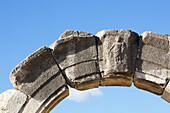 Low Angle View Of Stone Arch And Carving Against A Blue Sky; Philippi, Greece