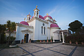 Greek Orthodox Church With Pink Domes And Gold Crosses; Capernaum, Israel