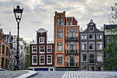 Einzigartige Wohngebäude und ein Laternenpfahl; Amsterdam, Niederlande