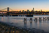Sunset Over Lower Manhattan Near World Trade Center And Williamsberg Bridge; Brooklyn, New York, United States Of America