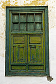 Weathered Green Wooden Window With Light Green Shutters In Weathered White Stucco Wall; Lanzarote, Canary Islands, Spain