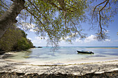 Boat On Calm Waters Of A White Sand Beach