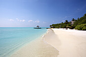 Classic White Sand Beach With Blue Sea And Overwater Cabana