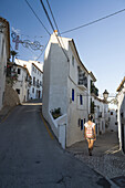 A Chinese Young Woman Walking On The Street Of The Beautiful Town Of Altea In Costa Blanca; Altea, Alicante, Spain