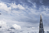 A Close Up View Of The Shard And A Nearby Helicopter, Taken From Millennium Bridge; London, England