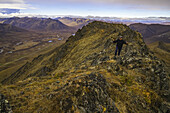 Man Hiking On A Lookout Overlooking The Blackstone Valley, Along The Dempster Highway; Yukon, Canada