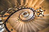 View directly up of a spiral staircase and chandeliers, Duino Castle; Trieste, Friuli Venezia Giulia, Italy