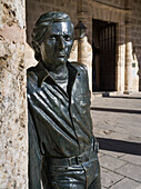 Statue of a man looking at the camera while leaning on a wall; Havana, Cuba