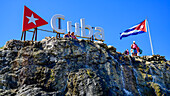 Tourists at Cuba sign; Havana, Cuba