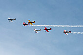 The West Coast Raves flying team fly in formation in their custom-built RV Airplanes performing aerobatic manoeuvres in the 2019 Olympic Air Show, Olympic Airport; Olympia, Washington, United States of America
