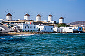 Windmills in a row along the coast of the Mediterranean Sea; Mykonos Town, Mykonos Island, Cyclades, Greece