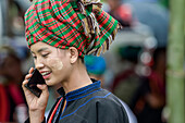 Modern Burmese young woman on smart phone; Yawngshwe, Shan State, Myanmar