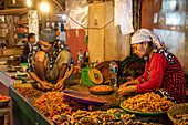 Chili pepper vendors at the market; Manado, North Sulawesi, Indonesia