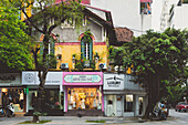 Street corner with trees and shops; Hanoi, Vietnam