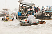 Man transporting food in boat, Cai Rang Floating Market; Can Tho, Vietnam