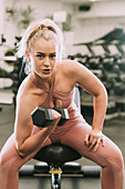 Woman working out with weights; Wellington, New Zealand