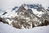 Caution sign in the backcountry below Mont Blanc at an alpine resort; Courmayeur, Valle D'Aosta, Italy