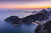 Glowing sunset over the Atlantic ocean and the coastline of hills and beaches of Rio de Janeiro; Rio de Janeiro, Rio de Janeiro, Brazil