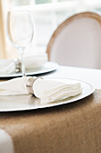 Simple and elegant place setting with plate charger and napkin